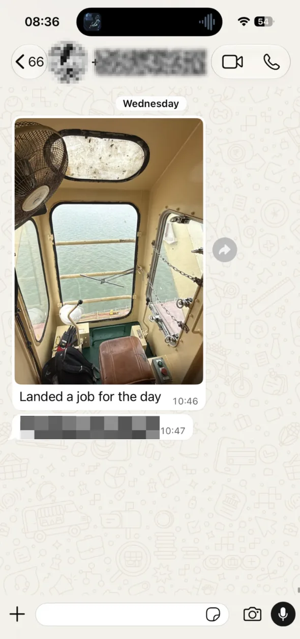 WhatsApp photo from inside a crane cab with the message that he landed a job for the day