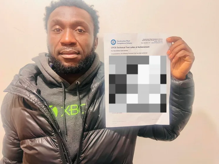 Student holding up his CPCS technical test letter of achievement