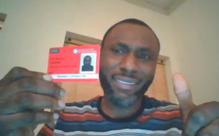 Student holding up his red CPCS trained operator card