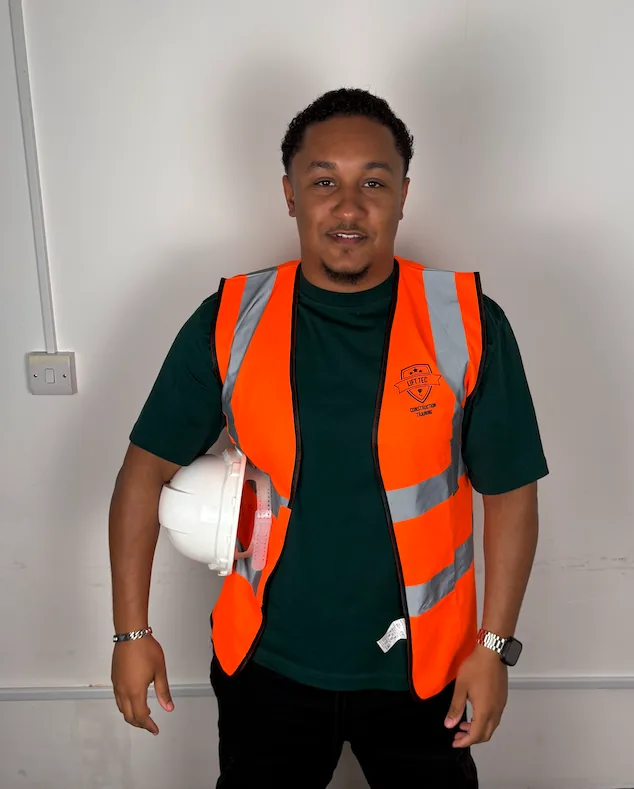 Student in a Lift Tec hi vis vest holding his white helmet